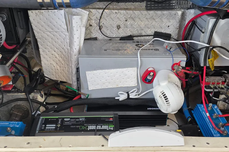 Slide: The Image of Engine compartment of a 2001 Cruisers Yachts 340 Express with battery and wiring setup. - 62