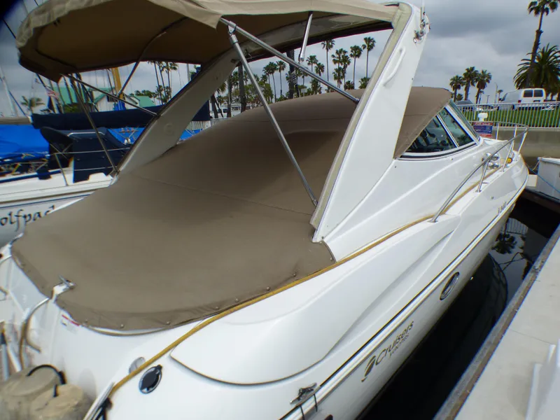 Slide: The Image of 2001 Cruisers Yachts 340 Express with cover in marina. - 7