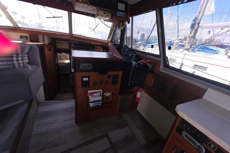 Slide: The Image of Interior of 1986 Bayliner 3888 MY Sedan yacht with helm and seating area. - 13