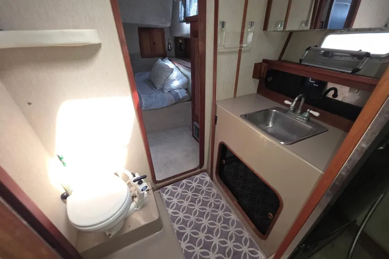Slide: The Image of Interior of 1986 Bayliner 3888 MY Sedan with bathroom and cozy sleeping area. - 14