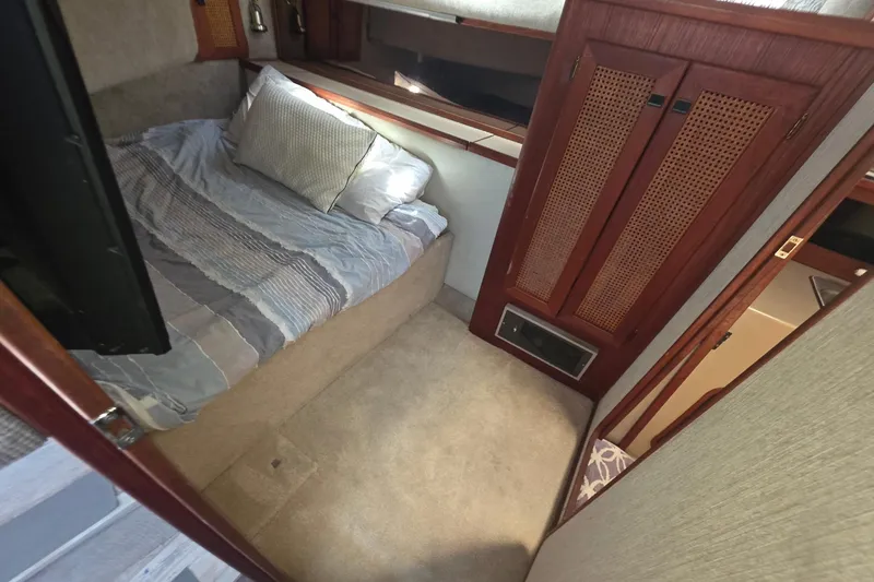 Slide: The Image of Cozy cabin interior of 1986 Bayliner 3888 MY Sedan with bed and wooden cabinetry. - 17