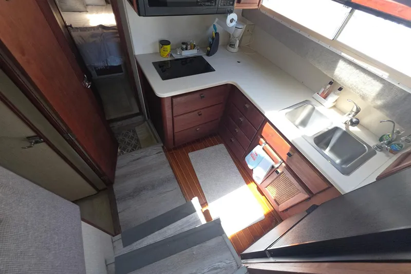 Slide: The Image of Interior of 1986 Bayliner 3888 MY Sedan yacht kitchen with sink and stove. - 18