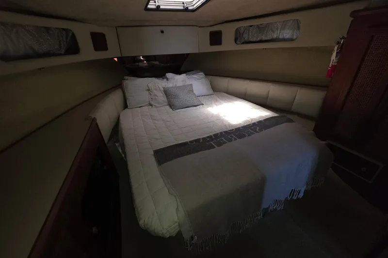 Slide: The Image of Cozy bedroom interior of 1986 Bayliner 3888 MY Sedan yacht with comfortable bedding. - 20