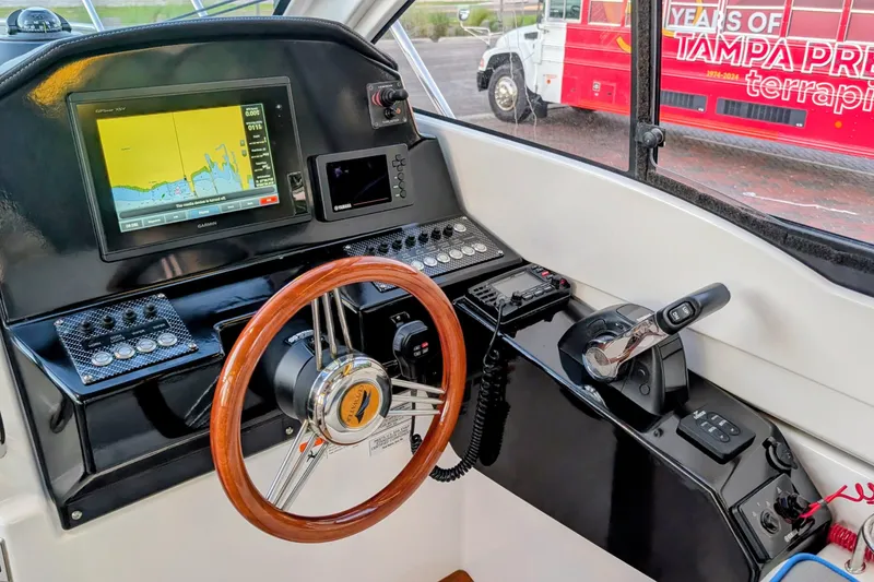 Slide: The Image of 2017 Cutwater C-24 Coupe helm with navigation display and wooden steering wheel. - 28