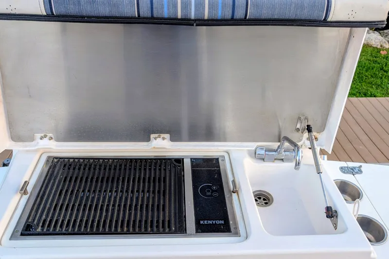 Slide: The Image of Outdoor kitchen setup on a 2017 Cutwater C-24 Coupe boat with grill and sink. - 15