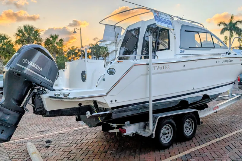 Slide: The Image of 2017 Cutwater C-24 Coupe boat on trailer with Yamaha outboard motor at sunset. - 52