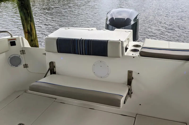 Slide: The Image of 2017 Cutwater C-24 Coupe boat interior with seating and cup holders by the water. - 13