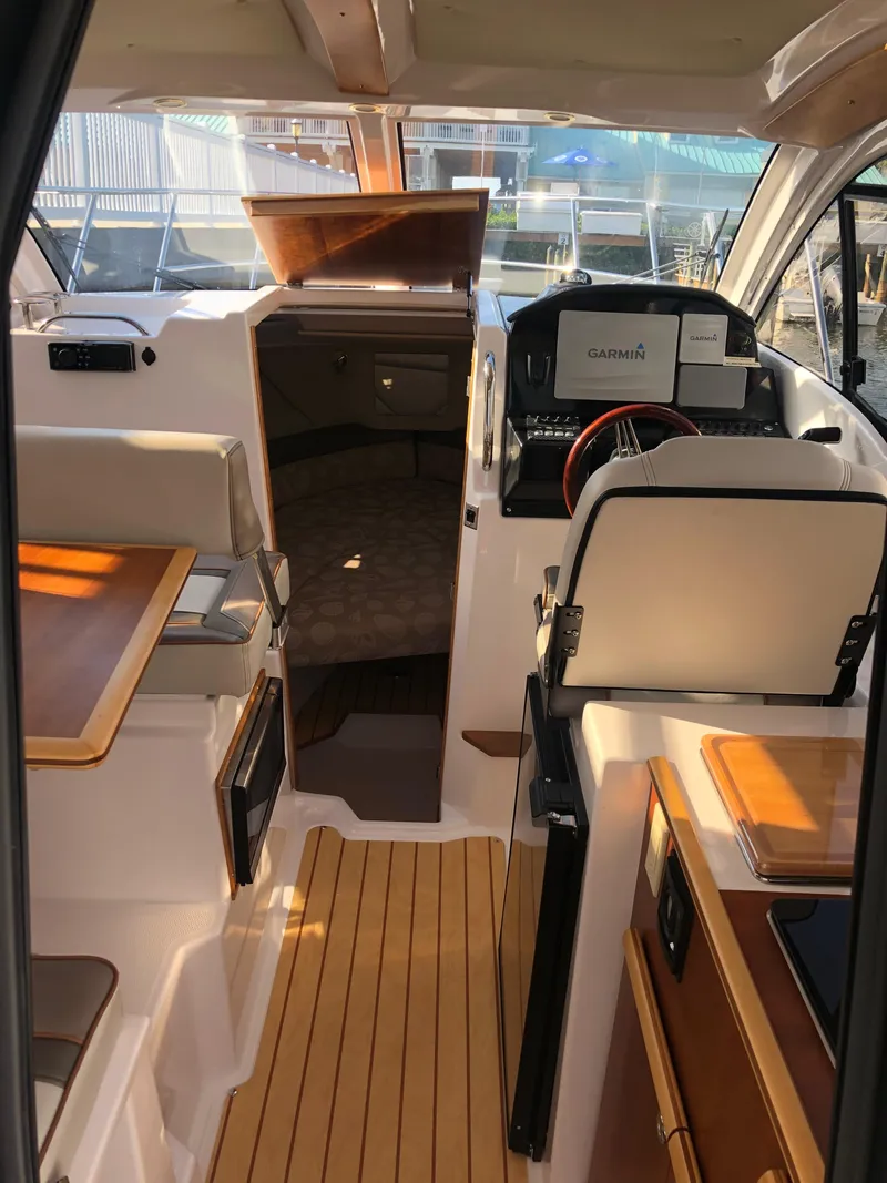 Slide: The Image of Interior of a 2017 Cutwater C-24 Coupe with wood flooring and seating area. - 39