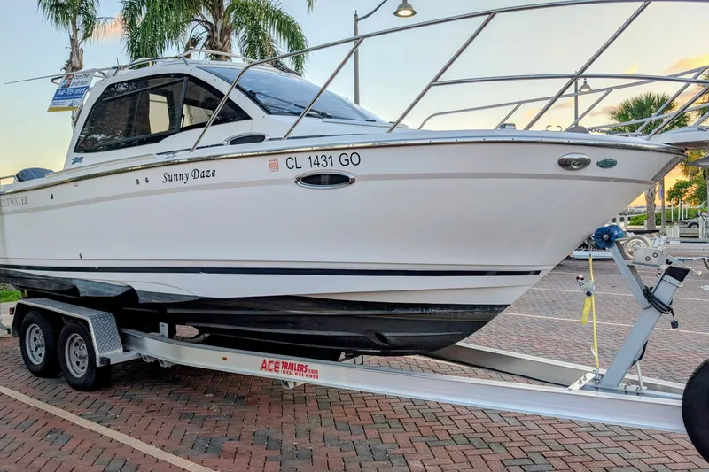 Slide: The Image of 2017 Cutwater C-24 Coupe boat on trailer, parked on brick pavement. - 60