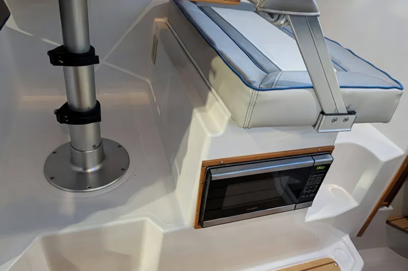 Slide: The Image of 2017 Cutwater C-24 Coupe interior with cushioned seat and built-in microwave. - 26