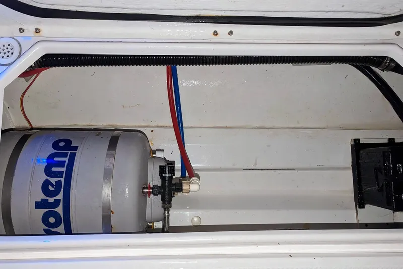 Slide: The Image of Interior view of a 2017 Cutwater C-24 Coupe boat showing a water heater system. - 46