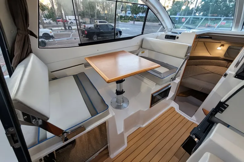 Slide: The Image of 2017 Cutwater C-24 Coupe interior with seating, table, and wood flooring. - 20