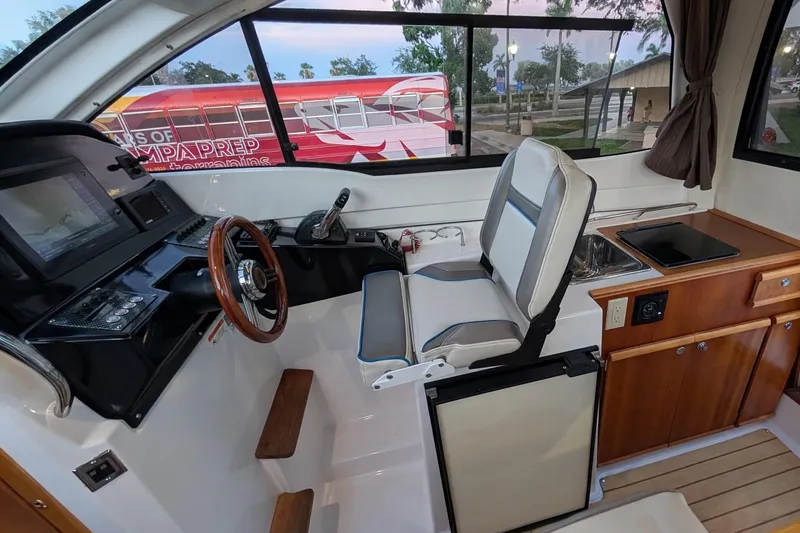 Slide: The Image of Interior of 2017 Cutwater C-24 Coupe boat with helm, seating, and kitchenette. - 30