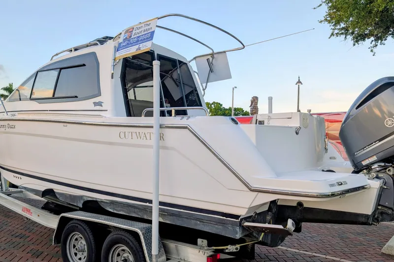 Slide: The Image of 2017 Cutwater C-24 Coupe boat on trailer, displayed outdoors. - 53