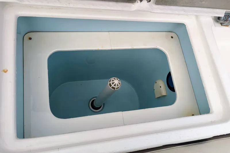 Slide: The Image of Livewell compartment in a 2017 Cutwater C-24 Coupe boat, featuring a clean interior. - 16