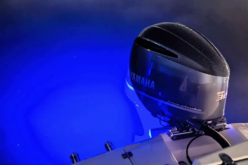 Slide: The Image of Yamaha outboard motor on 2017 Cutwater C-24 Coupe, illuminated by blue underwater lights. - 54