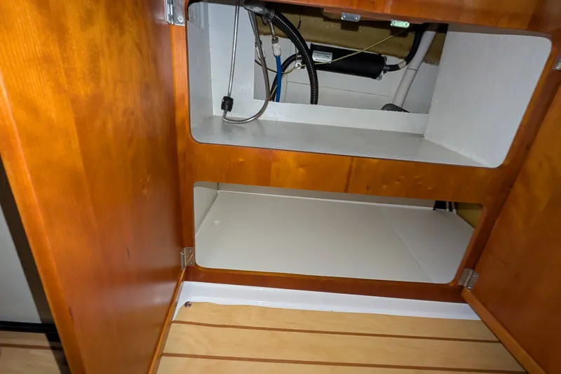 Slide: The Image of Wooden cabinet interior on a 2017 Cutwater C-24 Coupe boat. - 36