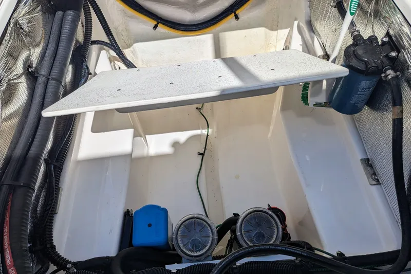 Slide: The Image of Engine compartment of a 2017 Cutwater C-24 Coupe boat, showcasing mechanical components. - 48
