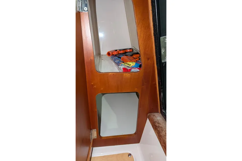 Slide: The Image of Interior storage compartment of 2017 Cutwater C-24 Coupe boat with tools and supplies. - 37