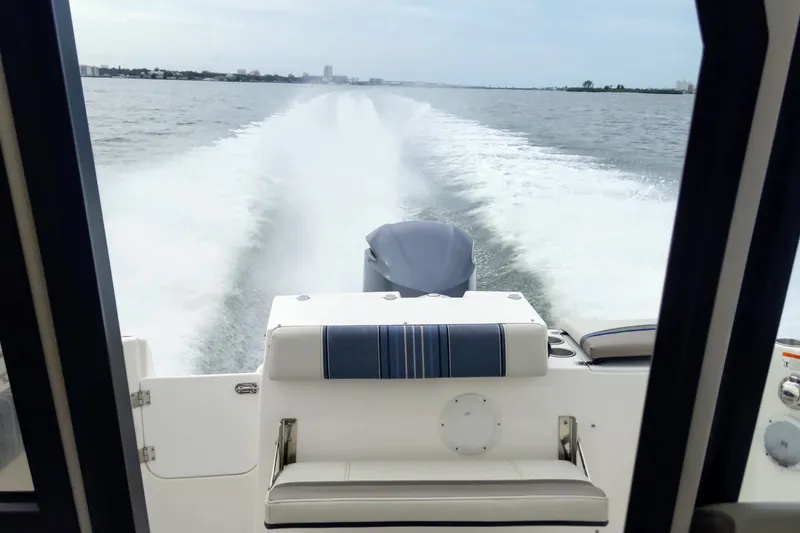 Slide: The Image of 2017 Cutwater C-24 Coupe cruising on open water, view from the cabin. - 12