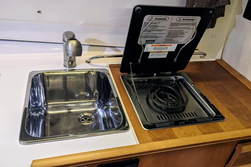 Slide: The Image of Compact kitchen area in a 2017 Cutwater C-24 Coupe with sink and stove. - 35