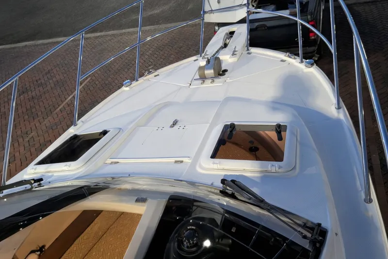 Slide: The Image of 2017 Cutwater C-24 Coupe boat deck with open hatches and railing. - 4