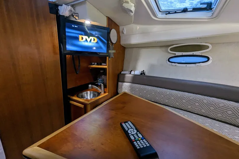 Slide: The Image of Interior of 2017 Cutwater C-24 Coupe with TV, remote, and seating area. - 43