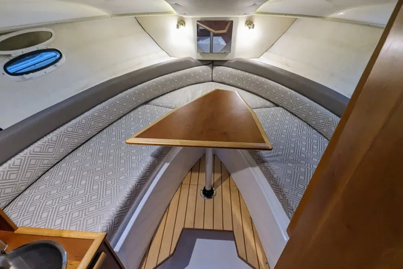 Slide: The Image of Interior of 2017 Cutwater C-24 Coupe boat with cushioned seating and wooden table. - 41