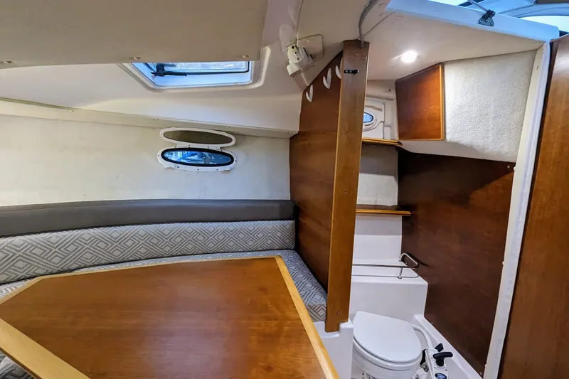 Slide: The Image of Interior of 2017 Cutwater C-24 Coupe, featuring cozy seating and compact marine toilet. - 44