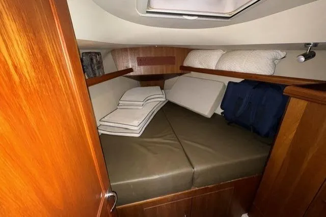 Slide: The Image of Cozy cabin interior of 2007 Hunter 38 sailboat with cushions and wooden finish. - 25