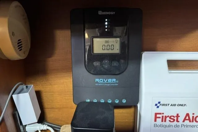 Slide: The Image of Renogy Rover charge controller in a 2006 Hunter 38 boat, near a first aid kit. - 22