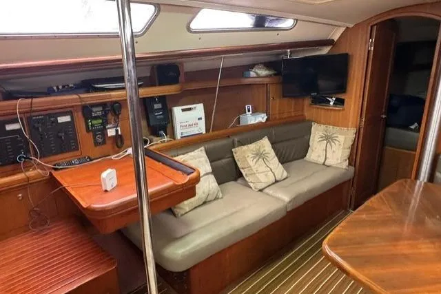 Slide: The Image of Interior of a 2007 Hunter 38 sailboat with cozy seating and navigation equipment. - 19