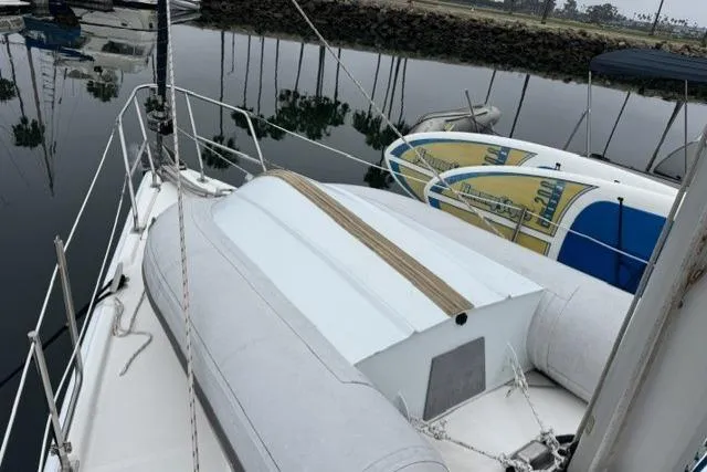 Slide: The Image of Sailboat deck with inflatable dinghy, Hunter 38 model, 2007, docked in calm waters. - 15