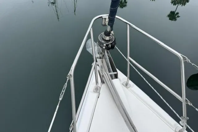 Slide: The Image of Bow of a 2007 Hunter 38 sailboat with calm water reflection. - 16