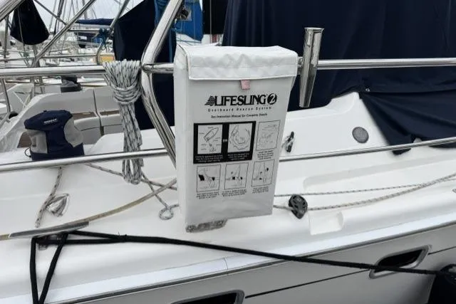 Slide: The Image of Lifesling 2 rescue system on a 2007 Hunter 38 sailboat, docked with visible rigging. - 28