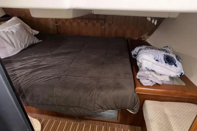 Slide: The Image of Cozy cabin interior of 2007 Hunter 38 sailboat with bed and wooden accents. - 26