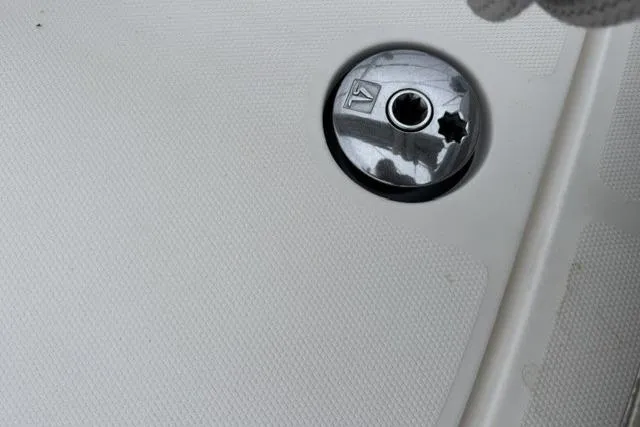 Slide: The Image of Deck fitting on 2007 Hunter 38 sailboat, featuring a metallic cap and textured surface. - 17