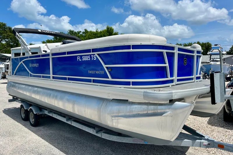 The Image of 2024 Godfrey Sweetwater 2286 SFL pontoon boat on trailer, blue exterior. - 1