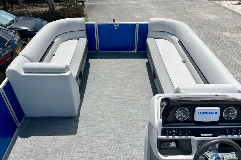 Slide: The Image of 2024 Godfrey Sweetwater 2286 SFL pontoon boat interior with plush seating and Lowrance dashboard. - 12