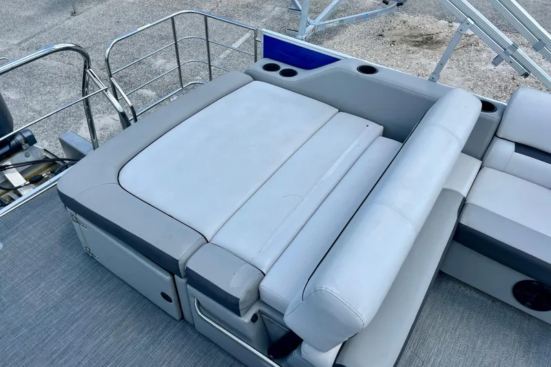 Slide: The Image of 2024 Godfrey Sweetwater 2286 SFL boat interior with cushioned seating and cup holders. - 13