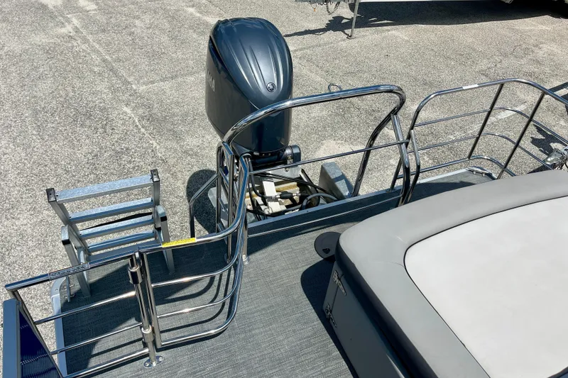 Slide: The Image of 2024 Godfrey Sweetwater 2286 SFL boat with outboard motor and rear seating area. - 19