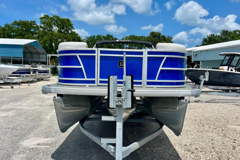 Slide: The Image of 2024 Godfrey Sweetwater 2286 SFL pontoon boat on trailer, blue exterior, sunny day. - 8