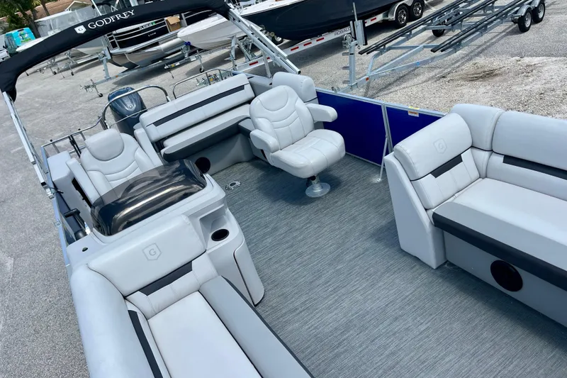 Slide: The Image of 2024 Godfrey Sweetwater 2286 SFL pontoon boat interior with plush seating and modern design. - 9