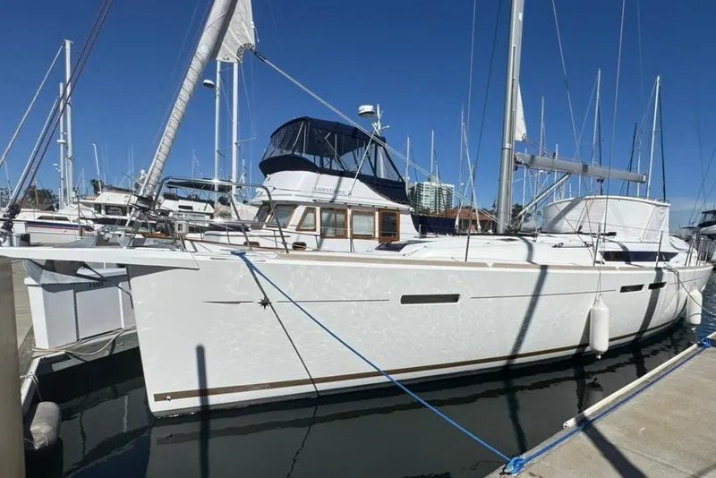 The Image of 2017 Jeanneau Sun Odyssey 449 sailboat docked at marina under clear blue sky. - 0
