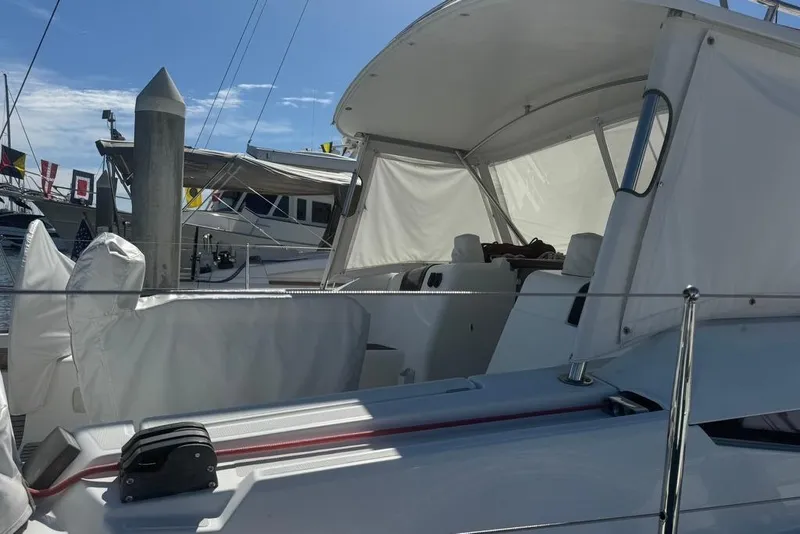 Slide: The Image of 2017 Jeanneau Sun Odyssey 449 sailboat with covered cockpit, docked at marina. - 11