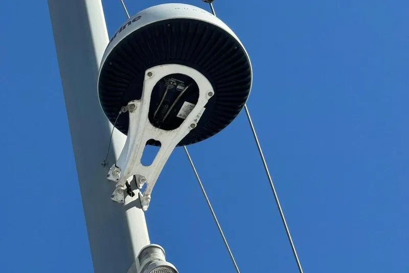 Slide: The Image of Radar equipment on Jeanneau Sun Odyssey 449 sailboat mast, 2017 model, against clear blue sky. - 16