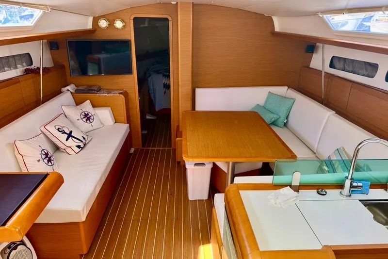Slide: The Image of Interior of 2017 Jeanneau Sun Odyssey 449 yacht with cozy seating and wooden finishes. - 23