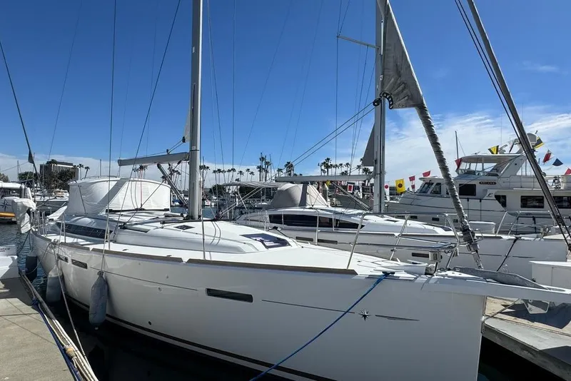 Slide: The Image of 2017 Jeanneau Sun Odyssey 449 sailboat docked at marina under clear blue sky. - 4