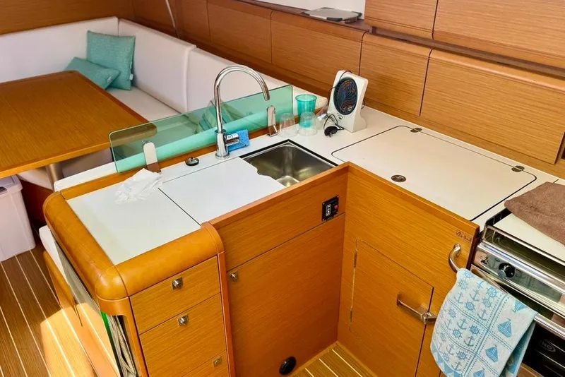 Slide: The Image of Interior of 2017 Jeanneau Sun Odyssey 449 yacht, featuring a modern kitchen and seating area. - 42