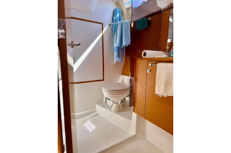 Slide: The Image of Bathroom interior of 2017 Jeanneau Sun Odyssey 449 yacht, featuring modern fixtures and wooden cabinetry. - 45